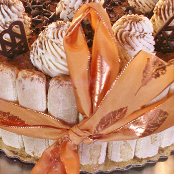 A cake with lady fingers and decorations